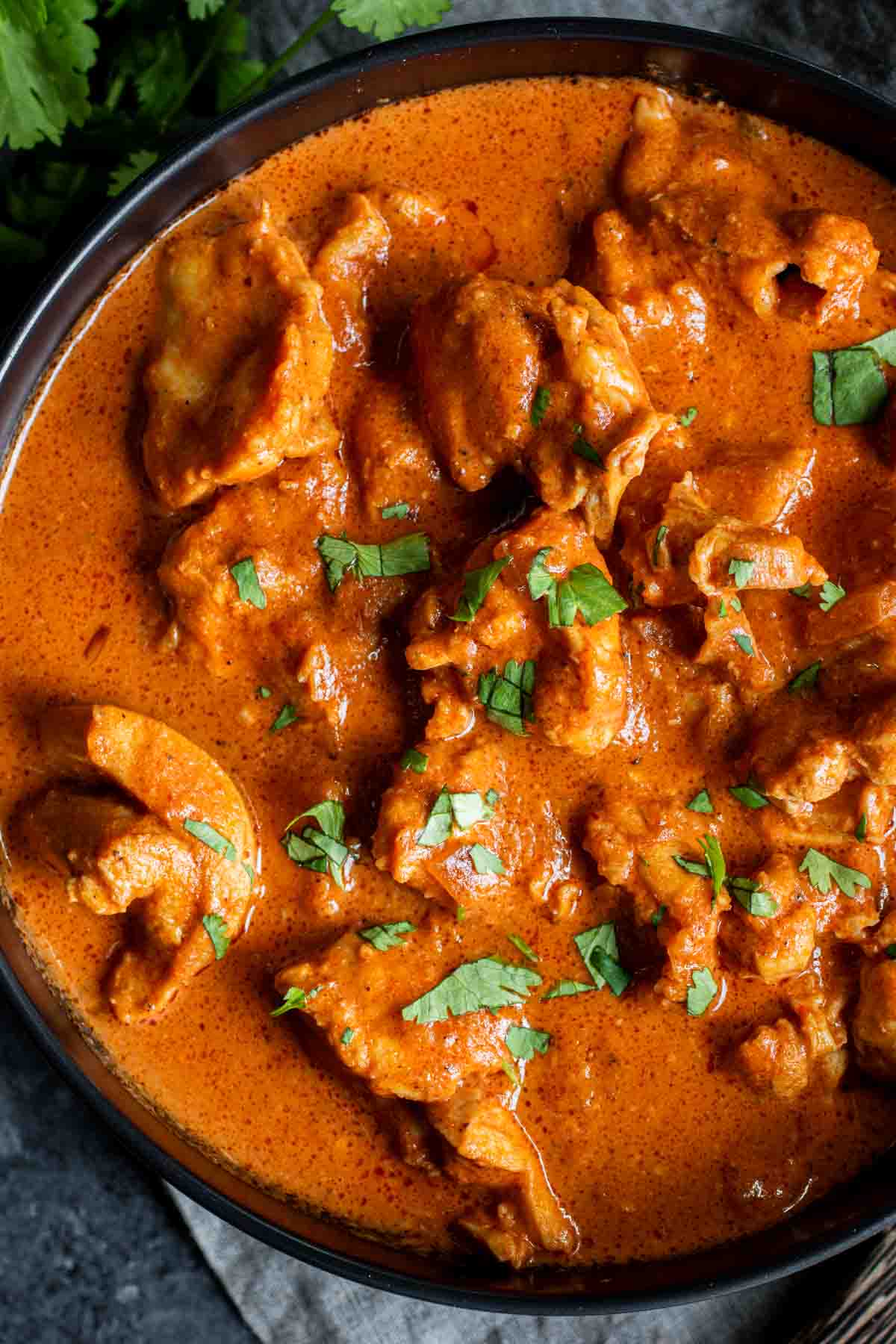 Instant Pot Butter Chicken in a black bowl.