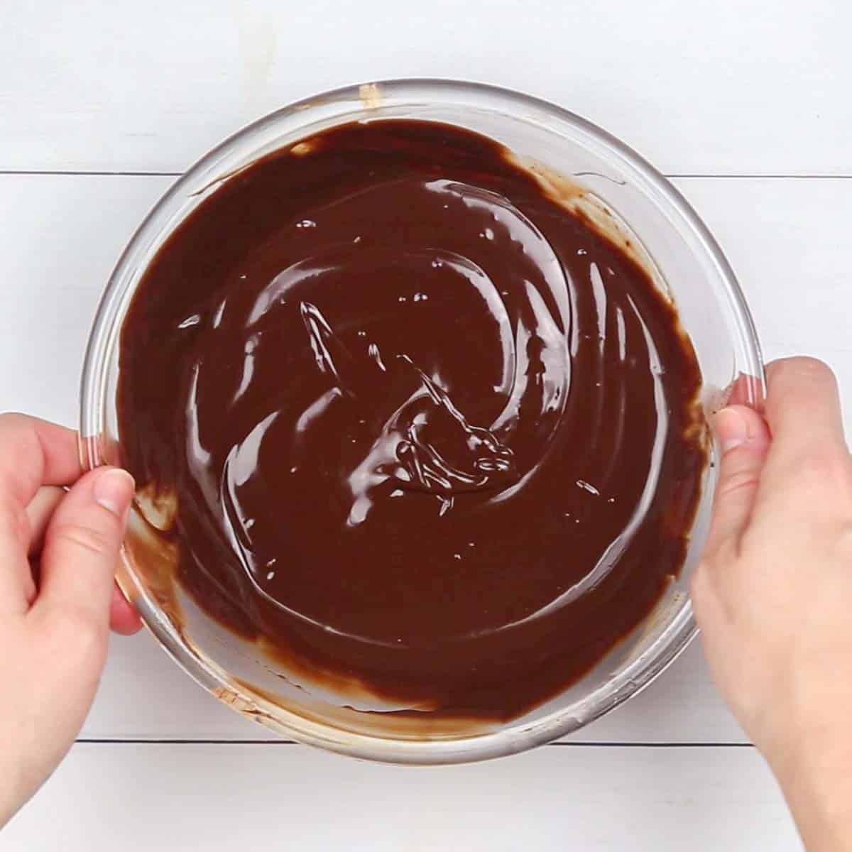 chocolate into a glass bowl to pour on a brownie cake