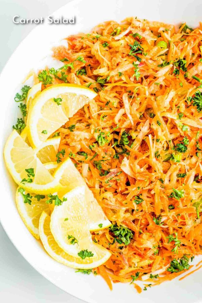pinterest photo of A plate of fresh carrot salad garnished with parsley and lemon slices.
