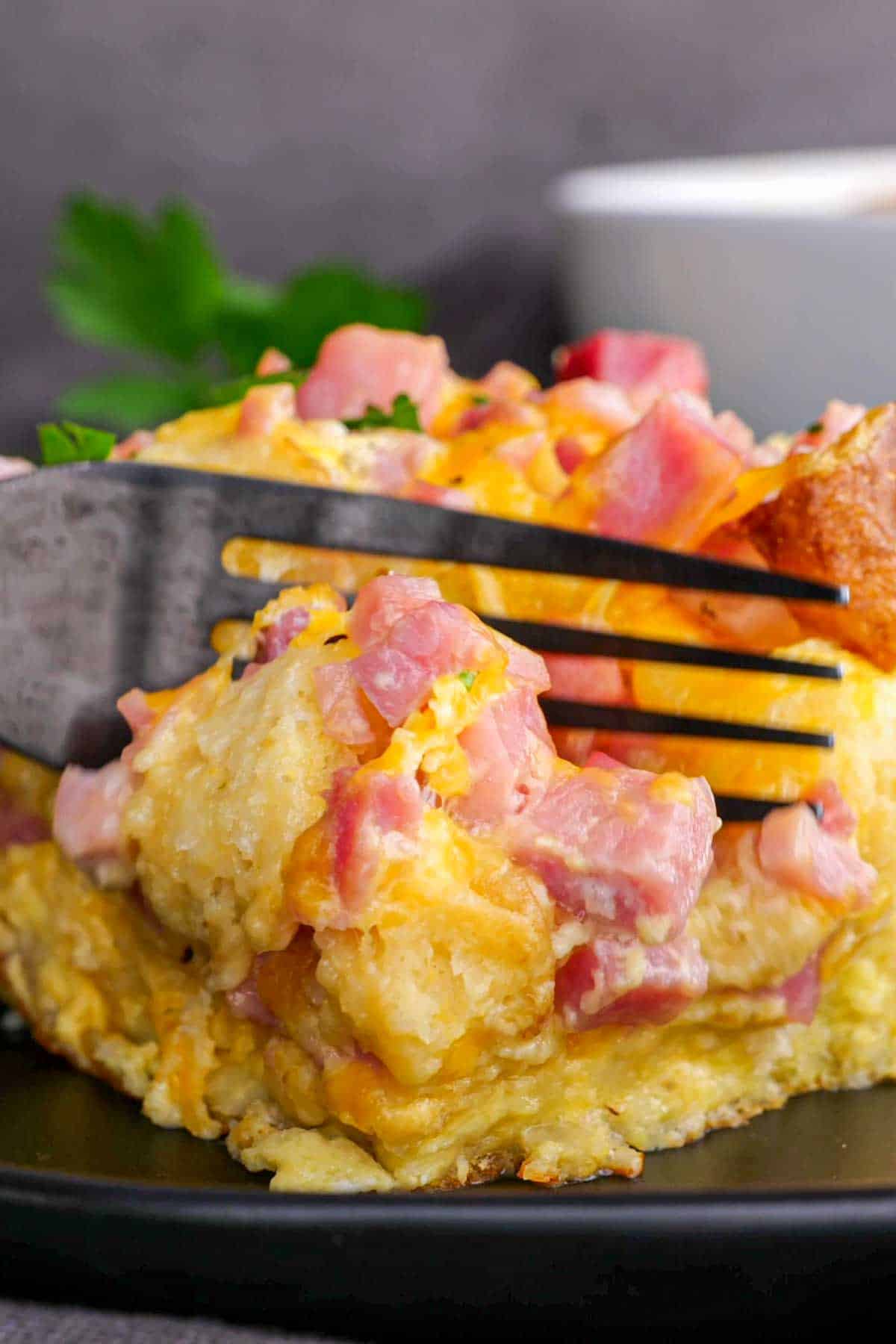 A fork on a Ham and Cheese English Muffin Breakfast Casserole