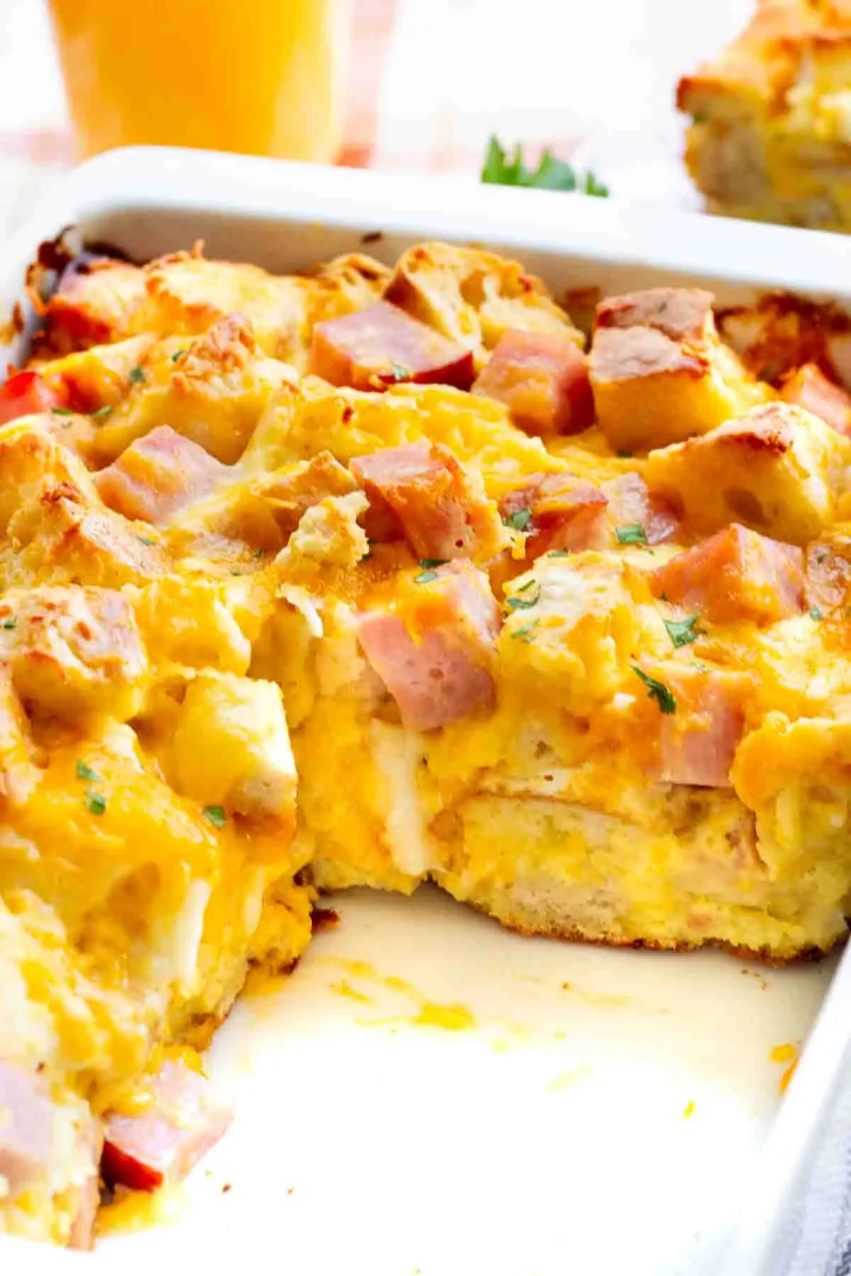 A Ham and Cheese English Muffin Breakfast Casserole in white dish