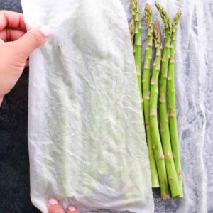 Wrapping fresh asparagus in a damp kitchen towel for Asparagus Goat Cheese Tart