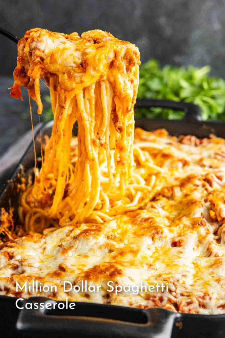 A serving of cheesy baked spaghetti casserole is being lifted from a baking dish, with melted cheese stretching from the dish. Text reads "Million Dollar Spaghetti Casserole.