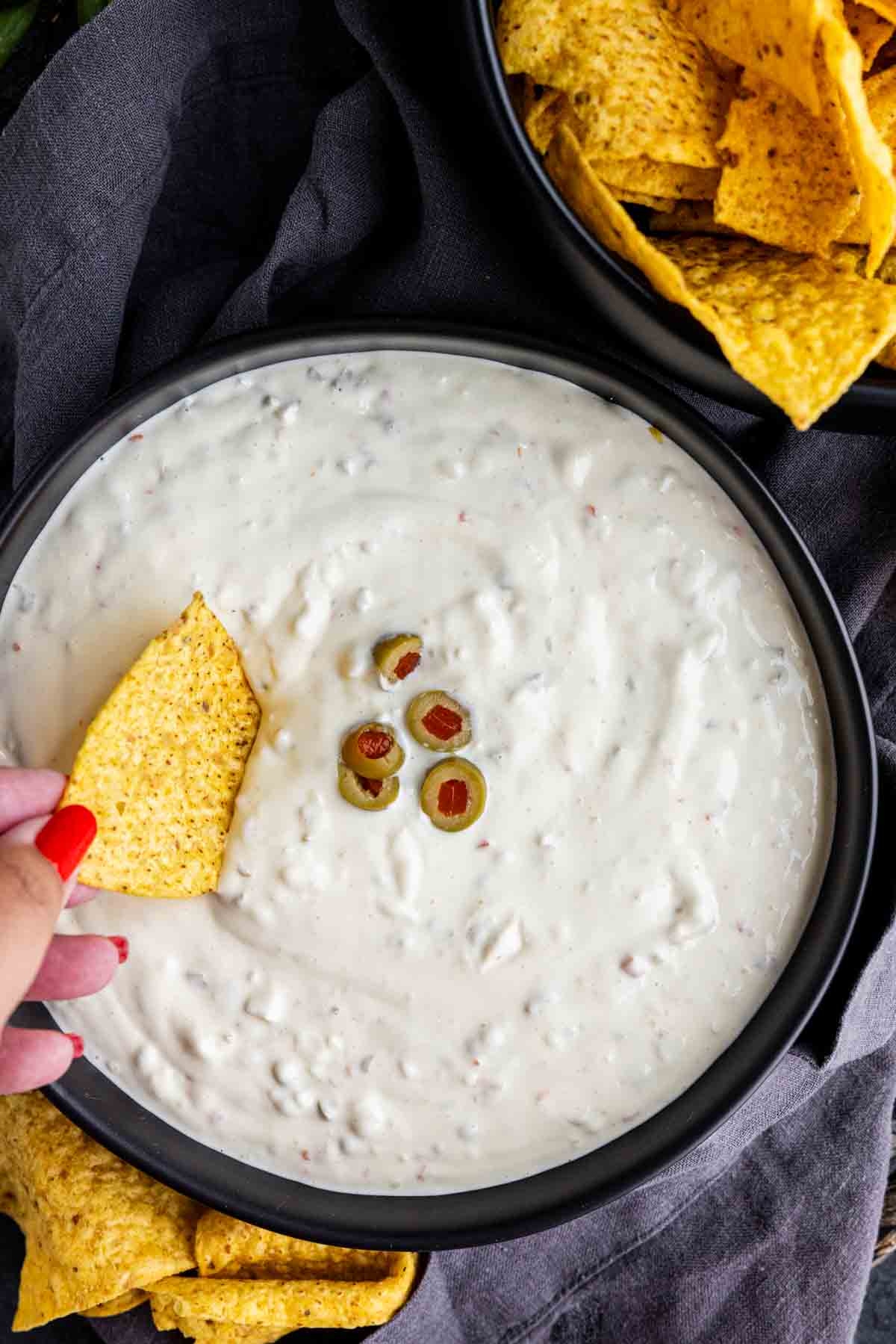 Hamlin’s White Dip served in a bowl with tortilla chips and chopped green olives