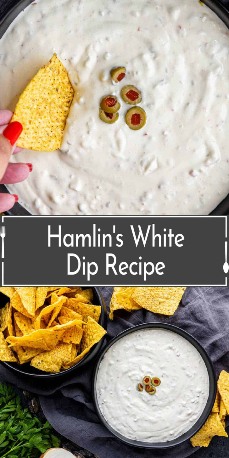 A bowl of creamy white dip topped with sliced green olives, surrounded by tortilla chips; a hand dips a chip into the bowl.