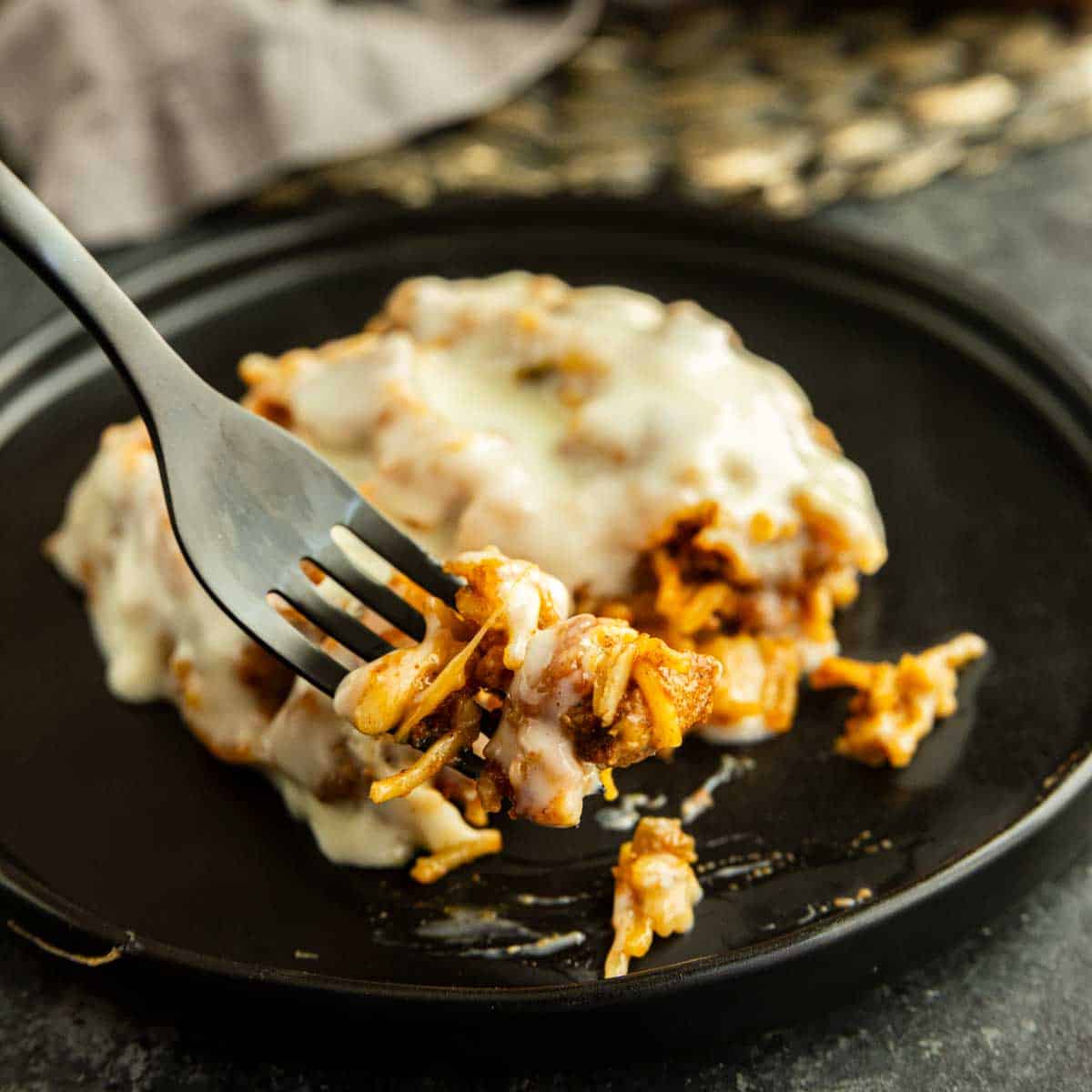 Viral Swim Queso Chicken and Rice casserole covered in creamy queso.